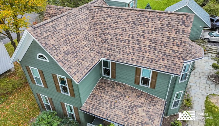 Classic home with a multi-colored asphalt shingle roof installation.